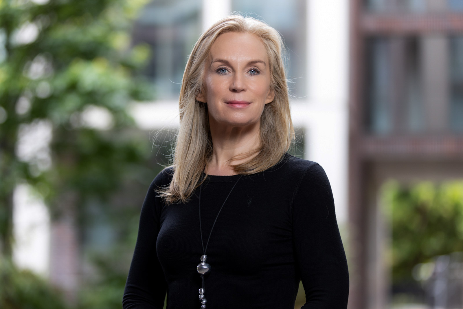 Woman standing outdoors with office block behind. Dublin corporate headshots